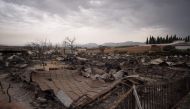 A general view shows a burnt holiday park in Mollina near Malaga on August 10, 2020. A wind-fuelled fire ripped through a holiday park in Spain that is home to a large number of British pensioners, destroying dozens of homes and injuring two people, offic