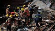Fire fighters look for survivors at the scene of an explosion in a residential area of Baltimore, Maryland, U.S., August 10, 2020. REUTERS/Carlos Barria