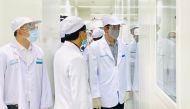 This handout photo taken and released on August 11, 2020 by Presidential Palace shows President Joko Widodo (R) visiting the Bio Farma Pharmacy that produce vaccines for COVID-19 coronavirus in Bandung, West Java. Indonesia on August 11, 2020 launched hum