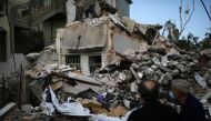 Locals look at a destroyed house where the wife and two of the daughters of Syrian refugee Ahmed Staifi were killed following a massive explosion, in Beirut, Lebanon, August 11, 2020. REUTERS/Alkis Konstantinidis
