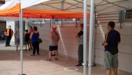 People queue outside a medical centre to be tested for the novel coronavirus in Santa Coloma de Gramenet, north of Barcelona, on August 10, 2020. Spain has added 19,405 new coronavirus cases in the past week, but the health ministry says the country is no