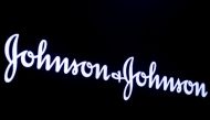 FILE PHOTO: The company logo for Johnson & Johnson is displayed on a screen to celebrate the 75th anniversary of the company's listing at the New York Stock Exchange (NYSE) in New York, U.S., September 17, 2019. REUTERS/Brendan McDermid/File Photo