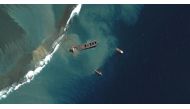 A view shows Japanese bulk carrier ship MV Wakashio as it begins to break apart, after it ran aground on a reef in Mauritius, in this August 15, 2020 satellite image provided by Maxar Technologies. Satellite image ?2020 Maxar Technologies/Handout via REUT