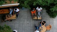 FILE PHOTO: People enjoy drinks at a cafe which reopened to the public for the first time since the start of the coronavirus disease (COVID-19) restrictions in Amman, Jordan June 6, 2020. REUTERS/Muhammad Hamed/File Photo