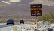 A sign warns of extreme heat as tourists enter Death Valley National Park in California June 29, 2013. REUTERS/Steve Marcus/File Photo