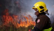 A firefighter monitors a spot fire in an area of the Amazon rainforest, near Porto Velho, Rondonia State, Brazil August 16, 2020. REUTERS/Ueslei Marcelino