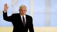 Mexico's President Andres Manuel Lopez Obrador waves as he arrives to hold a news conference at the presidential hangar, with the presidential plane in the background, at Benito Juarez International Airport in Mexico City, Mexico July 27, 2020. REUTERS/He