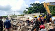This handout photo received on August 18, 2020 from the Facebook page of Javee Vallecer shows rescuers looking for survivors at the site of a damaged house after a 6.6-magnitude earthquake hit the town of Cataingan in the central Philippine province of Ma