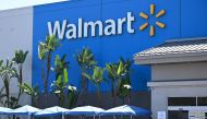 In this file photo taken on July 22, 2020 people wearing face coverings wait in line to shop at Walmart, in Burbank, California.  / AFP / Robyn Beck