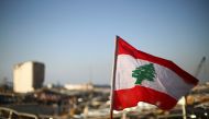 A Lebanese flag is pictured, in the aftermath of a massive explosion, in Beirut's damaged port area, Lebanon August 17, 2020. REUTERS/Hannah McKay
