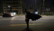 A Chilean trader and so-called 'Batman solidario' (Solidarity Batman) walks after delivering charity food rations in the street, during the global outbreak of the coronavirus disease (COVID-19) in Santiago, Chile August 12, 2020. Picture taken August 12, 
