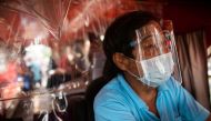 A jeepney driver wears a face mask and face shield, both mandatory in public transportation, to help curb coronavirus disease (COVID-19) infections, in Quezon City, Metro Manila, Philippines, August 19, 2020. REUTERS/Eloisa Lopez