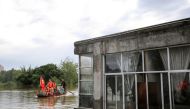 Community workers and volunteers deliver food and supplies to flood-affected residents after heavy rains in Neijiang in China's southwestern Sichuan province on August 19, 2020. China OUT / AFP / STR