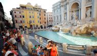 People not wearing face masks take selfies in front of the Trevi Fountain following a government decree that states face coverings must be worn between 6 p.m. and 6 a.m. near bars and pubs and in areas where gatherings are more likely, due to the coronavi