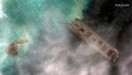 A satellite image shows the broken-up Japanese bulk carrier ship MV Wakashio, that ran aground on a reef last month causing an oil spill, off the coast of Pointe d'Esny, Mauritius August 15, 2020. Image taken August 15, 2020. Satellite image ©2020 Maxar T