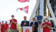 Turkish Finance Minister Berat Albayrak and Energy Minister Fatih Donmez applaud on the deck of drilling vessel Fatih in the western Black Sea, off Turkey, yesterday.