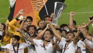 Players of Sevilla celebrate their victory after their team crowned 2020 UEFA Europa League champions with a 3-2 win against Italy's Inter Milan at the Rhein-Energie stadium in Cologne, Germany on August 21, 2020. Jesus Spinola - Anadolu