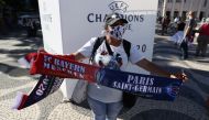 A fan poses with a scarf ahead of the Champions League final REUTERS/Rafael Marchante
 