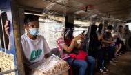 Jeepney passengers seated between plastic barriers, wear face masks and face shields mandatory in public transportation, to help curb coronavirus disease (COVID-19) infections, in Quezon City, Metro Manila, Philippines, August 19, 2020. REUTERS/Eloisa Lop