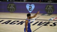 Philadelphia 76ers center Joel Embiid (21) stands midcourt before the game against the Boston Celtics as banners commemorating the birthday of late Los Angeles Lakers player Kobe Bryant are displayed in game four of an NBA basketball first-round playoff s