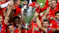 Bayern Munich v Paris St Germain - Estadio da Luz, Lisbon, Portugal - August 23, 2020 Bayern Munich's Thomas Muller with teammates celebrate with the trophy after winning the Champions League, as play resumes behind closed doors following the outbreak of 