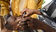In this file photo taken on April 22, 2017 A Health worker administers a vaccine to a child during a vaccination campaign against polio at Hotoro-Kudu, Nassarawa district of Kano in northwest Nigeria. The World Health Organization (WHO) is to certify the 