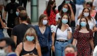 People wearing protective masks walk in a street in Nantes as France reinforces mask-wearing as part of efforts to curb a resurgence of the coronavirus disease (COVID-19) across the country, France, August 24, 2020. REUTERS/Stephane Mahe
