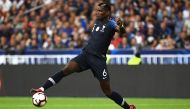 This file photo taken on September 10, 2018 shows France's midfielder Paul Pogba jumping for the ball during the UEFA Nations League football match between France and Netherlands at the Stade de France stadium, in Saint-Denis, northern of Paris. / AFP / A