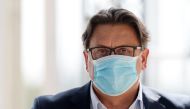 Chief Executive Officer of French pharmaceutical group Sanofi Paul Hudson wearing a face mask during a session of the employers' association Medef' s summer meeting at the Longchamp horse racetrack in Paris on August 27, 2020. / AFP / ERIC PIERMONT