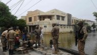 Troops install a water pump to remove water from a flooded residential area following heavy monsoon rains triggered floods in Pakistan's port city of Karachi on August 31, 2020./ AFP / Asif HASSAN