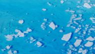 Chunks of ice float inside of meltwater pools on top of the Helheim glacier near Tasiilaq, Greenland, June 19, 2018. REUTERS/Lucas Jackson/File Photo/File Photo