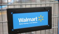 In this file photo the Walmart logo is displayed on a shopping cart at a Walmart store on August 15, 2013 in Chicago, Illinois. US retail giant Walmart said on August 27, 2020 it had teamed with Microsoft in a bid to buy short-form video app TikTok. / AFP