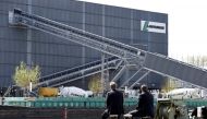 (FILES) This file photo taken on April 7, 2014 shows people sitting along the river, across from the French cement company Lafarge-Holcim, in Paris. / AFP / Franck FIFE