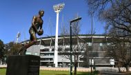 A sculpture of former Aussie Rules footballer player Jim Stynes is displayed outside the Melbourne Cricket Ground (MCG), the spiritual home of Australian Rules Football (AFL), in Melbourne on September 2, 2020. / AFP / William WEST
