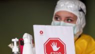 FILE PHOTO: An employee at Klinicaire medical center waits at the entrance of a checking area set to examine patients suffering from coronavirus (COVID-19) symptoms in Brussels, Belgium March 27, 2020. REUTERS/Yves Herman


