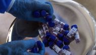 In this picture taken on September 1, 2020, a health official collects swab samples taking from people to test for the COVID-19 coronavirus at a testing site in Karachi./ AFP / Rizwan TABASSUM / To go with AFP story Pakistan-virus-health, FOCUS by Kaneez 