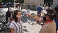 FILE PHOTO: People have their temperature checked before attending The Metropolitan Museum of Art on their first day open since closing due to the coronavirus disease (COVID-19) outbreak in the Manhattan borough of New York City, New York, U.S., August 27