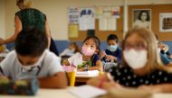 Secondary school students, wearing protective face masks, work in a classroom at the College Henri Matisse school during its reopening in Nice as French children return to their schools after the summer break with protective face masks and social distanci