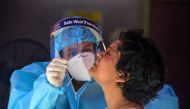 A health official collects nasal swab samples from a woman (R) for a Covid-19 coronavirus test at a primary health centre in Siliguri on September 5, 2020. AFP / Diptendu DUTTA