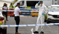 Police forensics officers gather evidence near to evidence markers inside a cordon on Irving Street, following a major stabbing incident in the centre of Birmingham, central England, on September 6, 2020.  AFP / Oli SCARFF