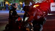FILE PHOTO: Police officers detain a demonstrator during a protest against police violence and racial injustice in Portland, Oregon, U.S., August 24, 2020. REUTERS/Terray Sylvester/File Photo
