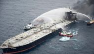 This handout photograph taken on September 8, 2020, and released by Sri Lanka's Air Force shows fireboats battling to extinguish a fire on the Panamanian-registered crude oil tanker New Diamond, some 60 km off Sri Lanka's eastern coast where a fire was re