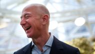 FILE PHOTO: Amazon founder and CEO Jeff Bezos laughs as he talks to the media while touring the new Amazon Spheres during the grand opening at Amazon's Seattle headquarters in Seattle, Washington, U.S., January 29, 2018. REUTERS/Lindsey Wasson/File Photo