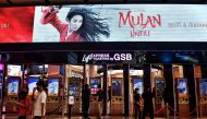 People buy tickets for Disney’s Mulan film at a cinema inside a shopping mall in Bangkok on September 8, 2020. / AFP / Lillian SUWANRUMPHA