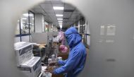 In this photograph taken on September 2, 2020, workers pack syringes at the Hindustan Syringes factory in Faridabad. / AFP / SAJJAD HUSSAIN