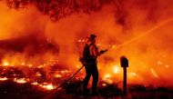 A Butte County firefighter douses flames at the Bear fire in Oroville, California on September 9, 2020.  AFP / JOSH EDELSON