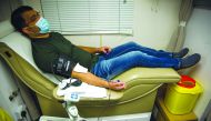 An employee of Barwa Real Estate Group donating blood under a blood donation campaign conducted in Barwa headquarters in Al Sadd.