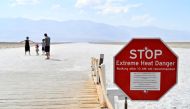 A warning sign alerts visitors of the extreme heat dangers at Badwater Basin, the lowest point in North America at 279 feet below sea level, in Death Valley National Park, California, U.S. August 17, 2020. REUTERS/David Becker/File Photo