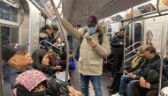 FILE PHOTO: A man with a face mask rides the subway in the Queens borough of New York City, U.S. February 2, 2020. REUTERS/Nick ZieminskiREUTERS