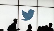 (FILES) In this file photo taken on August 13, 2019, employees walk past a lighted Twitter logo as they leave the company's headquarters in San Francisco. / AFP / Glenn CHAPMAN

